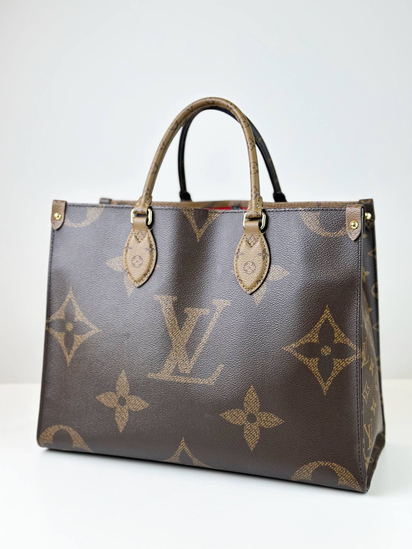 LOUIS VUITTON ON THE GO MM REVERSE MONOGRAM HANDBAG