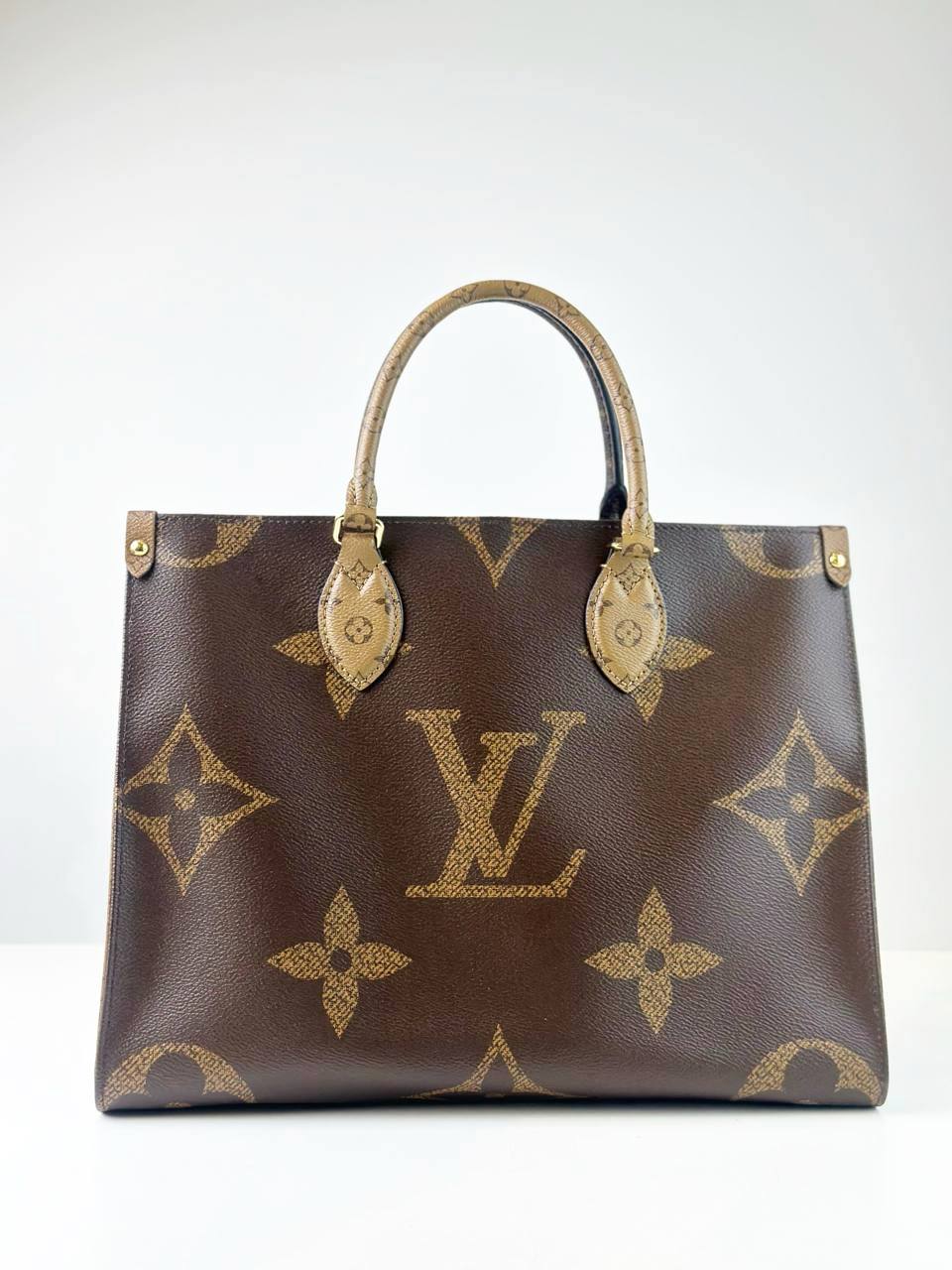 LOUIS VUITTON ON THE GO MM REVERSE MONOGRAM HANDBAG