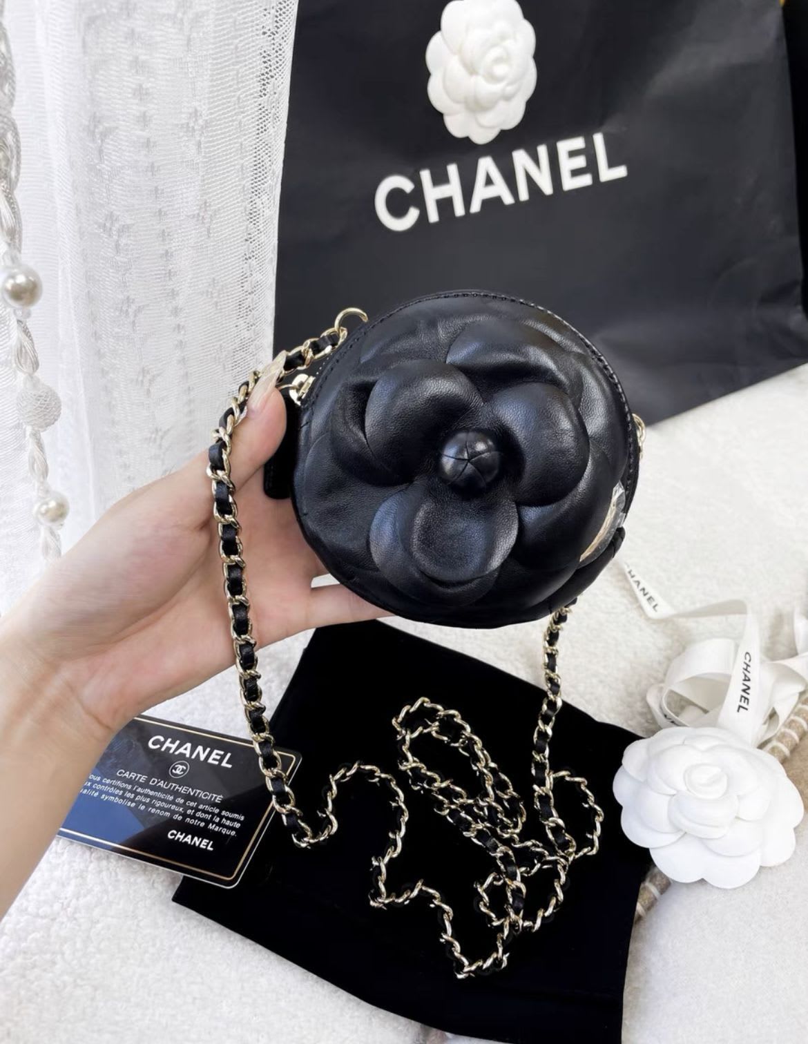 Chanel black camellia round chain bag